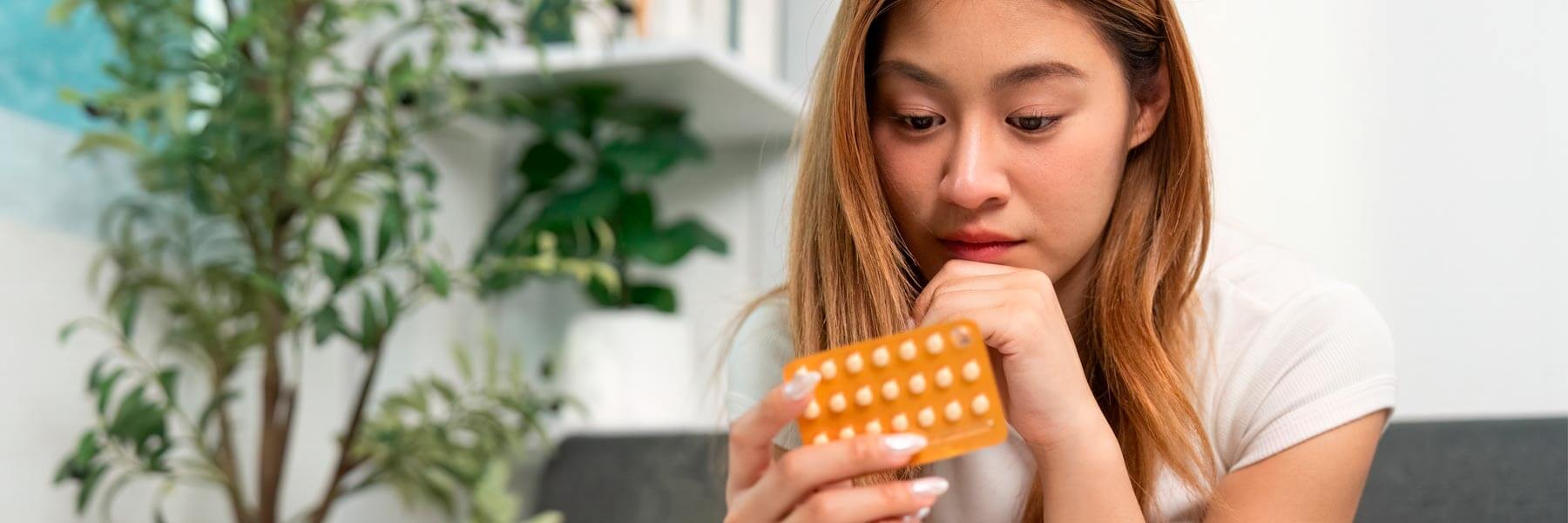 Woman taking contraceptives for fertility